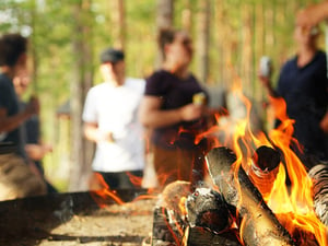 Showell team gathering around a fire